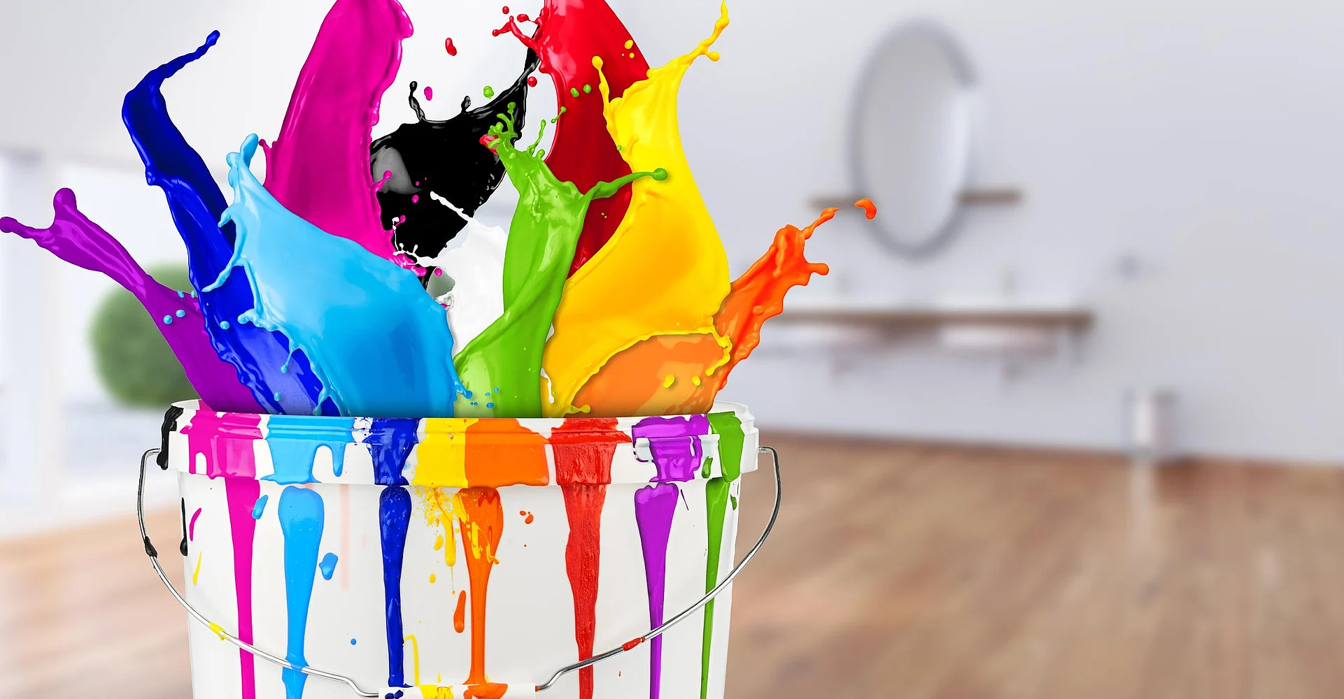 Bunte Farbe spritzt aus einem Eimer